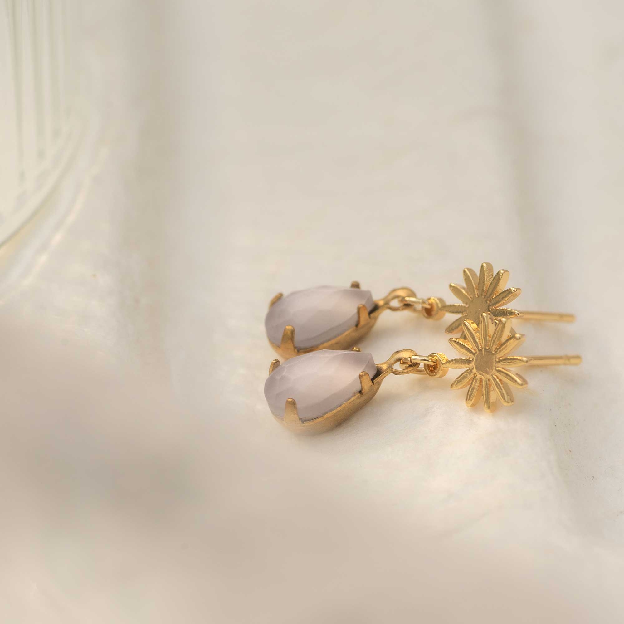 Gold earrings with lavender stones and gold flowers
