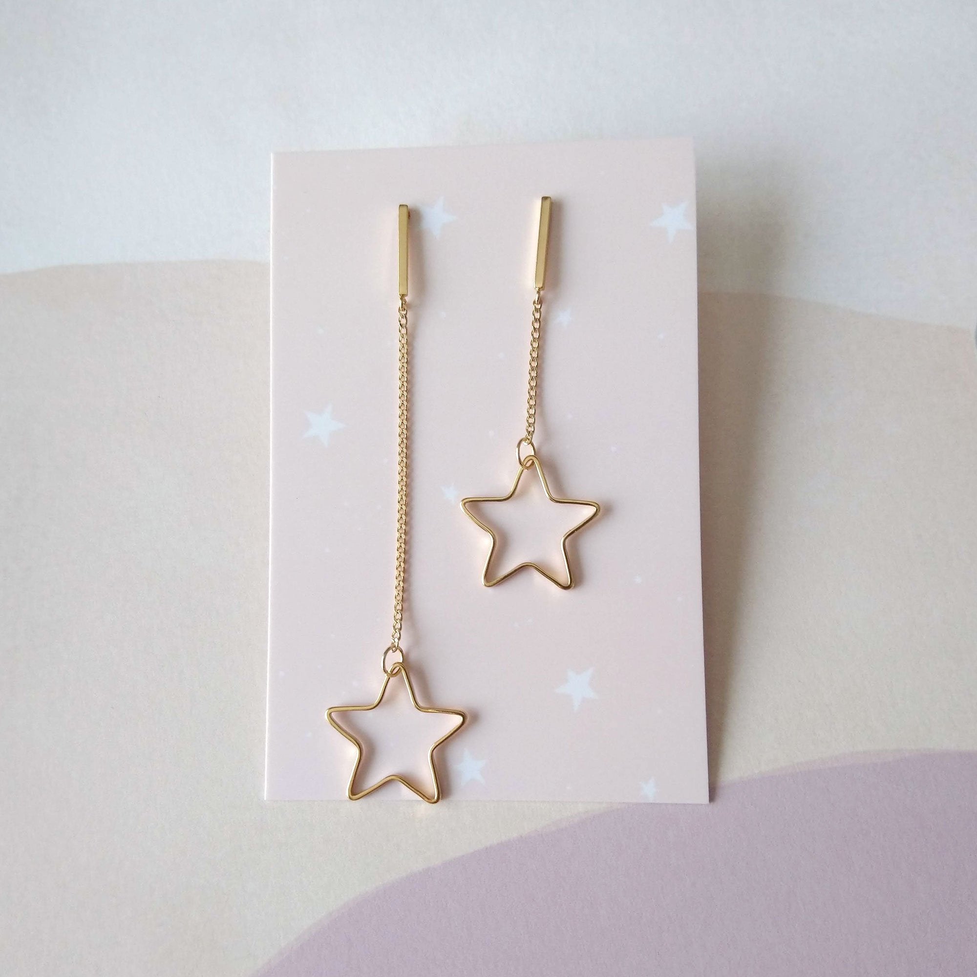 asymmetrical earrings gold stars